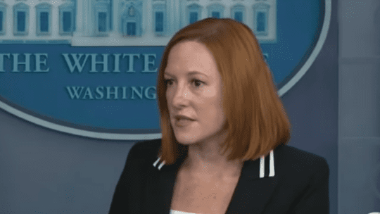 jen psaki in front of the White House logo at a press briefing