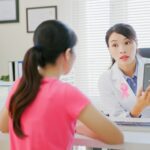 doctor shows woman breast screening imagery