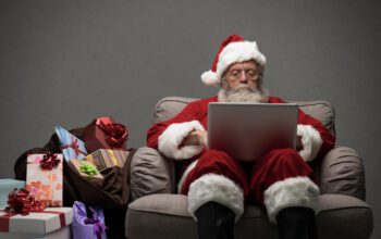 Santa responding to people on social media with his laptop