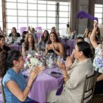 women cheering at a table at the 2025 PRNEWS Top Women in PR Awards