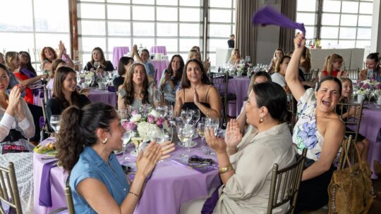 women cheering at a table at the 2025 PRNEWS Top Women in PR Awards